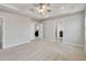 Large main bedroom with carpet, ceiling fan, and access to other rooms at 8277 Bower Bass Cir, Wesley Chapel, FL 33545