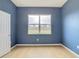 Simple bedroom with blue walls and wood floor at 10918 Ancient Futures Dr, Tampa, FL 33647