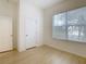 Bright bedroom with large window and wood-look floors at 10918 Ancient Futures Dr, Tampa, FL 33647