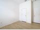 Simple bedroom with light walls, wood-look floors, and a closet at 10918 Ancient Futures Dr, Tampa, FL 33647