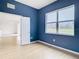 Blue bedroom with light wood floors and view of kitchen at 10918 Ancient Futures Dr, Tampa, FL 33647