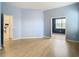 Bedroom with wood-look floors and a view into another room at 10918 Ancient Futures Dr, Tampa, FL 33647