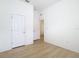 Bright bedroom with wood-look floors and access to another room at 10918 Ancient Futures Dr, Tampa, FL 33647