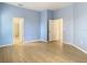 Bedroom with light blue walls and wood floors at 10918 Ancient Futures Dr, Tampa, FL 33647