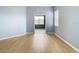 Bedroom with light blue walls and wood-look floors at 10918 Ancient Futures Dr, Tampa, FL 33647