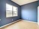 Blue bedroom with wood-look flooring and large window at 10918 Ancient Futures Dr, Tampa, FL 33647