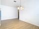 Simple dining room with wood-look floors and view to kitchen at 10918 Ancient Futures Dr, Tampa, FL 33647