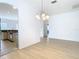 Bright dining room with light wood floors and a chandelier at 10918 Ancient Futures Dr, Tampa, FL 33647