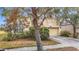 Tan house with a two-car garage and mature landscaping at 10918 Ancient Futures Dr, Tampa, FL 33647