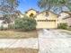 House exterior showcasing a two-car garage and landscaping at 10918 Ancient Futures Dr, Tampa, FL 33647