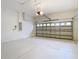 Spacious garage with open overhead door and white floor at 10918 Ancient Futures Dr, Tampa, FL 33647