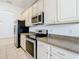 Kitchen features stainless steel appliances and light cabinets at 10918 Ancient Futures Dr, Tampa, FL 33647