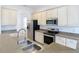 Modern kitchen with stainless steel sink and appliances at 10918 Ancient Futures Dr, Tampa, FL 33647