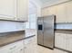 Kitchen with stainless steel refrigerator and light cabinets at 10918 Ancient Futures Dr, Tampa, FL 33647