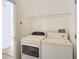 Laundry room with washer, dryer, and shelving at 10918 Ancient Futures Dr, Tampa, FL 33647