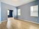 Light blue and wood-floored living room with views into another room and kitchen at 10918 Ancient Futures Dr, Tampa, FL 33647