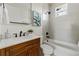 Modern bathroom with grey tile, a tub, and updated vanity at 1518 E Knollwood St, Tampa, FL 33610