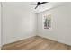 Simple bedroom with wood-look floors and ceiling fan at 1518 E Knollwood St, Tampa, FL 33610