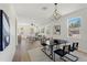 Bright dining area with modern light fixture and hardwood floors at 1518 E Knollwood St, Tampa, FL 33610