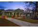 Charming craftsman style home with green exterior and brick accents at 1518 E Knollwood St, Tampa, FL 33610