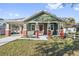 Green craftsman home with a covered porch and landscaped lawn at 1518 E Knollwood St, Tampa, FL 33610