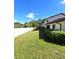 View of grassy backyard area with a white fence at 3600 Magnolia Ridge Cir # 1221-G, Palm Harbor, FL 34684