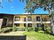 Condo building exterior, featuring balconies and landscaping at 3600 Magnolia Ridge Cir # 1221-G, Palm Harbor, FL 34684