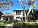 Front view of two story condo with landscaping and walkway at 3600 Magnolia Ridge Cir # 1221-G, Palm Harbor, FL 34684