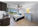 Bedroom with a queen-size bed, built-in desk, and a ceiling fan at 1120 North Shore Ne Dr # 201, St Petersburg, FL 33701