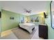 Light green bedroom with a ceiling fan and view of trees outside the window at 1120 North Shore Ne Dr # 201, St Petersburg, FL 33701