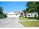 House exterior showcasing a three-car garage and well-maintained landscaping at 13267 Linzia Ln, Spring Hill, FL 34609