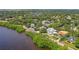 Aerial view of multiple houses on a lush, green waterfront property with stunning landscape and water views at 6231 Bayshore Blvd, Tampa, FL 33611