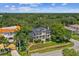 Stunning aerial view of a home on a lush green property with balconies and gorgeous landscape views at 6231 Bayshore Blvd, Tampa, FL 33611