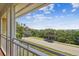 Balcony showcases road and distant ocean views, enhanced by lush greenery at 6231 Bayshore Blvd, Tampa, FL 33611