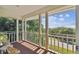 Balcony view showcases trees, the road, and distant water at 6231 Bayshore Blvd, Tampa, FL 33611