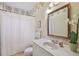 Bright bathroom with marble vanity top, decorative floral wallpaper, and classic fixtures at 6231 Bayshore Blvd, Tampa, FL 33611