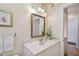 Well-lit bathroom featuring a marble vanity top and decorative wallpaper at 6231 Bayshore Blvd, Tampa, FL 33611