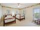 Charming bedroom with floral accents, twin beds, a ceiling fan, and decor at 6231 Bayshore Blvd, Tampa, FL 33611