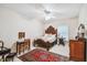 Well-appointed bedroom with a wooden bed frame, patterned rug, and neutral walls at 6231 Bayshore Blvd, Tampa, FL 33611