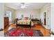 Bright bedroom with hardwood floors, ceiling fan, and a large oriental rug at 6231 Bayshore Blvd, Tampa, FL 33611