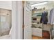 Walk-in closet with shelving and storage solutions, adjacent to a modern shower at 6231 Bayshore Blvd, Tampa, FL 33611