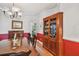 Dining room with hardwood floors, wooden furniture, and half red accent wall at 6231 Bayshore Blvd, Tampa, FL 33611