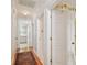 Hallway with hardwood floors leading to the kitchen with white cabinets at 6231 Bayshore Blvd, Tampa, FL 33611