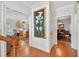 Hallway with wood floors, decorative art, and views into the kitchen and dining room at 6231 Bayshore Blvd, Tampa, FL 33611