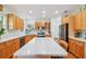 Bright kitchen featuring stainless steel appliances, wood cabinets, and a marble-top island at 6231 Bayshore Blvd, Tampa, FL 33611