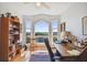 Bright home office space with a large window, vintage desk, and bookshelf featuring ocean views at 6231 Bayshore Blvd, Tampa, FL 33611