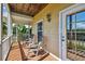 Inviting covered porch with rocking chairs and a view of the surrounding landscape at 6231 Bayshore Blvd, Tampa, FL 33611