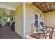 Relaxing porch with rocking chairs, wood floors, and sunlit exterior at 6231 Bayshore Blvd, Tampa, FL 33611