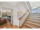 Wood staircase leading to the living room that has a fireplace and built-in shelves at 6231 Bayshore Blvd, Tampa, FL 33611