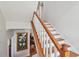 Traditional staircase features hardwood steps and white painted risers and banister at 6231 Bayshore Blvd, Tampa, FL 33611